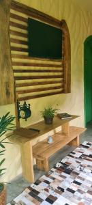 a living room with a tv on a wall at Cabana Refúgio do Hobbit-Gramado @refugiodohobbit in Gramado