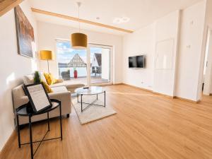 a living room with a couch and a table at Dill Apartment Pleinfeld am Brombachsee III in Pleinfeld