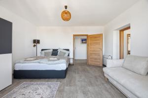 a bedroom with a bed and a couch at Appartement im Schloßhof in Rechnitz