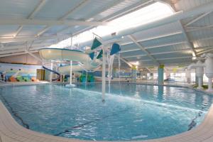a indoor swimming pool with a water slide at KL Caravan in Prestatyn