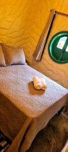 a bed in a tent with two towels on it at Cabana Refúgio do Hobbit-Gramado @refugiodohobbit in Gramado