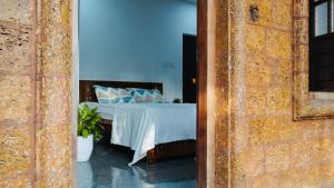 a bedroom with a bed with blue pillows at Villa Terra, Spacious 2BR Villa in Kannur +1 photo