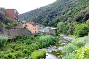 a river in a town next to a mountain at Varazze Mare in Varazze