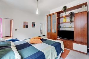 a bedroom with a bed and a flat screen tv at Varazze Mare in Varazze