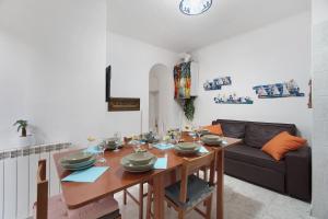 a dining room with a table and a couch at Varazze Mare in Varazze