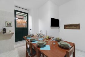 a dining room with a wooden table with chairs at Varazze Mare in Varazze