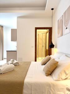a bedroom with a large bed with two pillows on it at S'Olivare Posada - Apartments in Posada