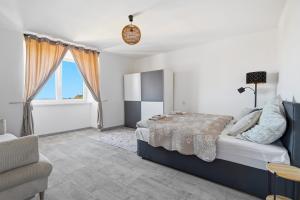 a bedroom with a bed and a large window at Appartement im Schloßhof in Rechnitz