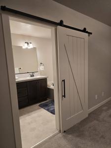 a bathroom with a door leading to a sink at Kwem Homes in Salem