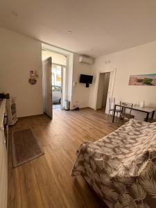 a bedroom with a bed and a living room at Caruso'S House1 in Syracuse