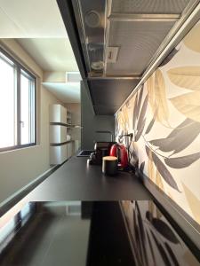 a kitchen with a counter with a tea kettle on it at Sibilla Suite - Manu Maison in Parma +2 photos