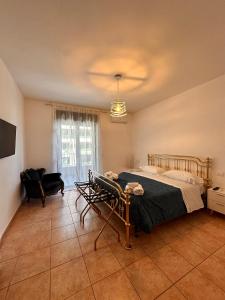 a bedroom with a bed and a chair and a window at Bari Double Sea View in Bari