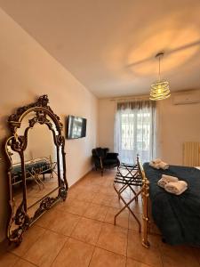 a room with a bed and a large mirror at Bari Double Sea View in Bari
