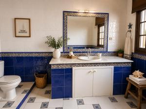 a bathroom with a sink and a mirror at Holibai Vila Santa Rita Vistas al mar cerca de Baiona in Oia +34 photos