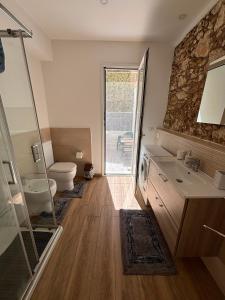 a bathroom with a sink and a toilet and a shower at Caruso'S House1 in Syracuse +14 photos