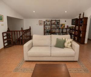 a living room with a couch and a staircase at Holibai Vila Santa Rita Vistas al mar cerca de Baiona in Oia