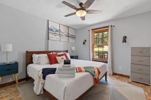a bedroom with a bed and a ceiling fan at Tatanka Hideaway Hot Tub Pool Table Massive Space in Custer