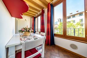 a small room with a table and a window at Happy Guest Apartments - Lake And Passion in Riva di Solto