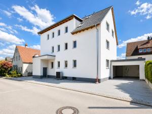 a white building with a garage at Dill Apartment Pleinfeld am Brombachsee III in Pleinfeld