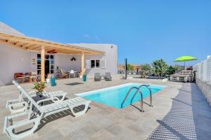 a villa with a swimming pool and a patio at Villa Brisa de Gairia in Antigua