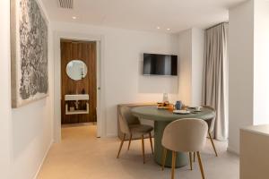 a living room with a green table and chairs at Suite 33 - Boutique Apartments in San Benedetto del Tronto