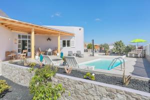 a villa with a swimming pool and a house at Villa Brisa de Gairia in Antigua