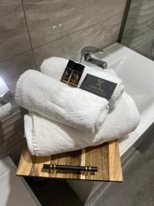 a pile of towels sitting on top of a bath tub at Hotel Palace Struga in Struga