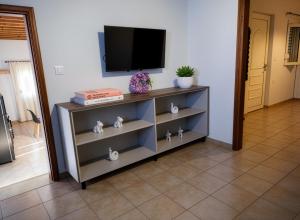 a shelf with a television on top of it at Casa Thea in Archangelos