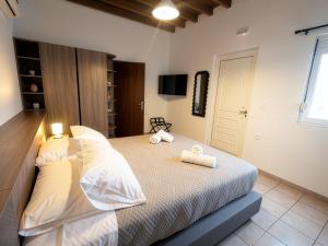 a bedroom with a bed with two towels on it at Casa Thea in Archangelos