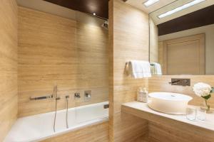 a bathroom with a sink and a mirror at Tivoli Palazzo 1880 Lecce Hotel in Lecce