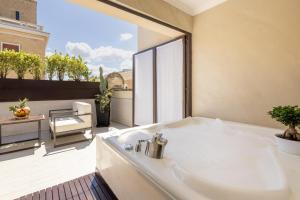a white bath tub sitting on top of a balcony at Tivoli Palazzo 1880 Lecce Hotel in Lecce +64 photos