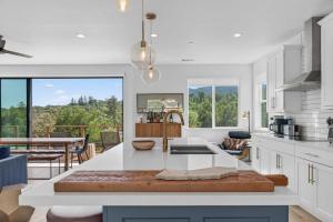 a kitchen with a white counter top and a table at Chardonnay Getaway in Glen Ellen