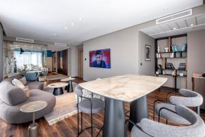 a living room with a table and chairs at The NINE Lifestyle Experience in Tunis