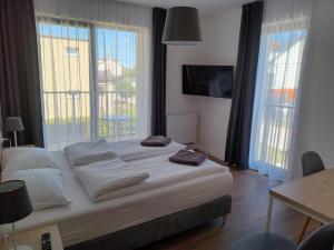 a bedroom with a bed and a large window at WILLA KORSARSKA in Władysławowo