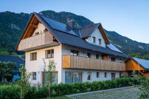 a house with solar panels on its roof at Start Point Apartments in Žirovnica