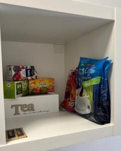 a white shelf with some food and drinks on it at Rooms Hvar in Hvar