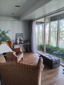 a living room filled with furniture and a large window at Santana Hotel & SPA in Vila do Conde