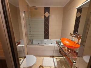 a bathroom with a sink and a bath tub at Apartment relax jacuzzi terrace with sea view in Brela