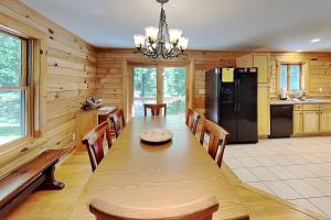 a dining room with a table and a refrigerator at Crazy Idea in Swanton