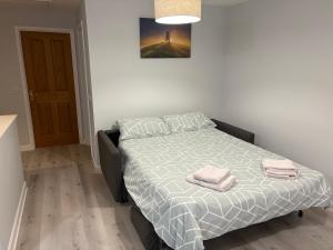 a bedroom with a bed with two towels on it at Flat At 34 in Street