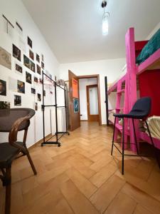a room with a pink staircase and chairs in it at Maison D'artiste Boutique Hostel in Tirana