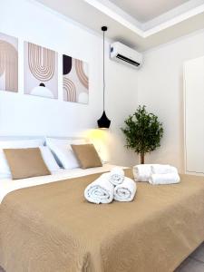 a bedroom with a large bed with towels on it at S'Olivare Posada - Apartments in Posada
