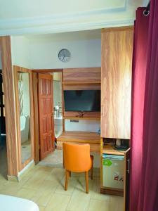 a room with a table and a chair in a room at New Land Sarl in Douala