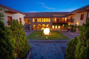 a large building with a large orb in the yard at Casa Cartagena Boutique Hotel & Spa in Cusco
