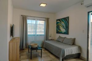 a bedroom with a bed and a window at Casa Tannat by Vindecaf in Cafayate +15 photos