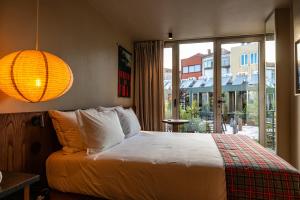 a bedroom with a bed and a large window at chic&basic Tokyo Hoose in Porto +55 photos