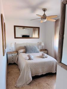 a bedroom with a bed with two towels on it at Apartamento con terraza y piscina en Malgrat de Mar in Malgrat de Mar +22 photos