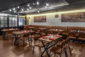 a restaurant with tables and chairs in a room at Four Points by Sheraton New York Downtown in New York
