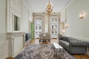 a living room with a couch and a table at Wyndham Grand Krakow Old Town in Krakow