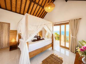 a bedroom with a bed with a teddy bear on it at SūKha Amed in Culik +28 photos